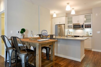 Dining area and kitchen with stainless steel appliances